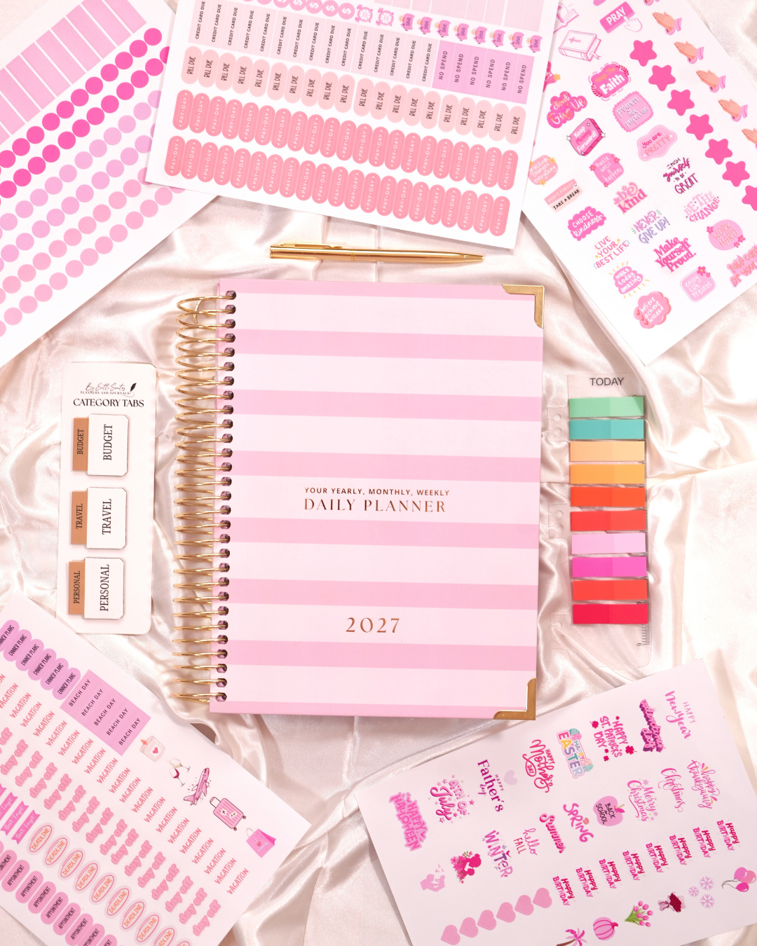 Pink striped 2027 Daily Spiral Planner with category tabs, sticky tabs, and planner stickers