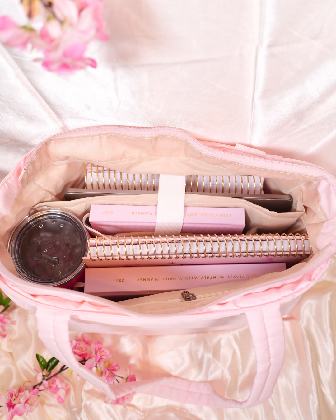 Top view inside the pink Travel Tote packed with planners and a tumbler
