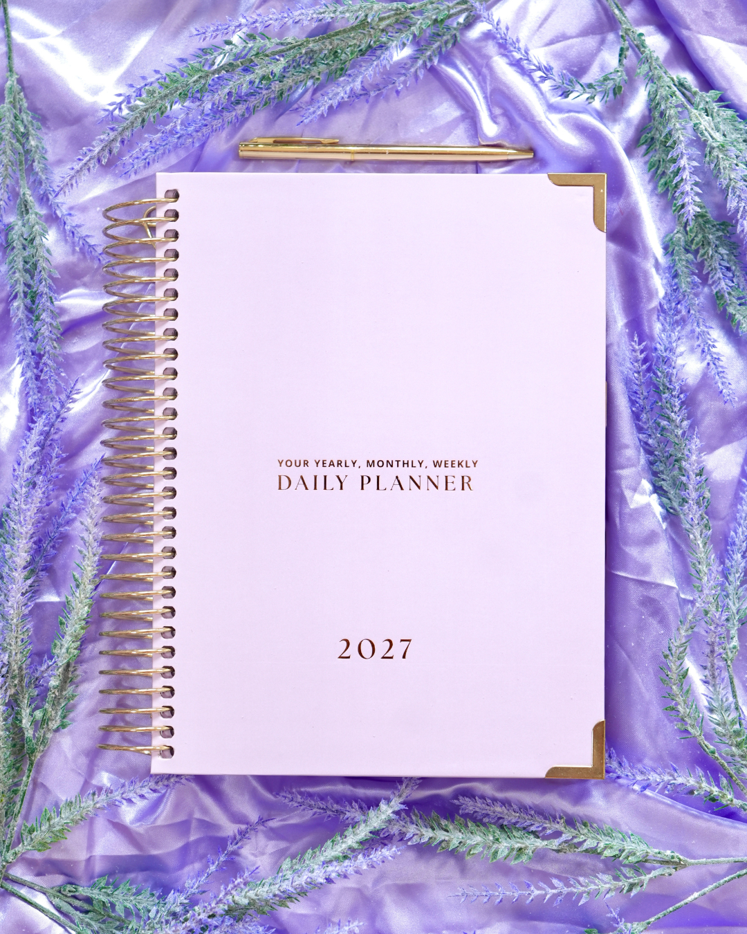 Purple 2027 Daily Spiral Planner with gold spiral binding and lavender sprigs