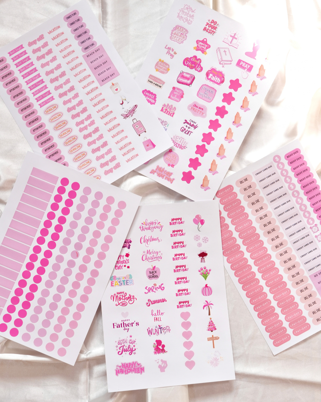 Sheets of pink planner stickers on cream satin